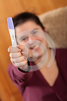 Woman holding a pregnancy test