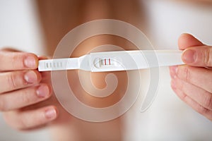 Woman Holding Pregnancy Test. Positive.
