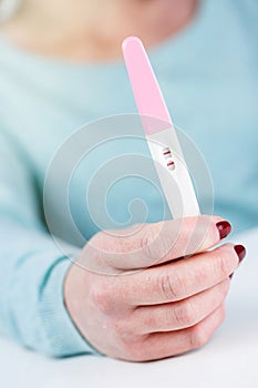 woman holding a Pregnancy Test pregnancy test positive result in
