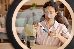 Woman holding pregnancy test recording female health videos
