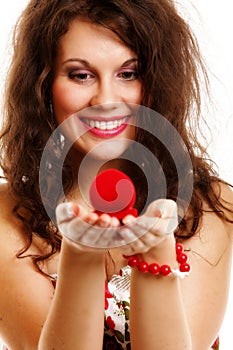 Woman holding a present with engagement ring