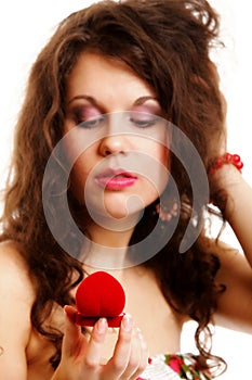 Woman holding a present with engagement ring