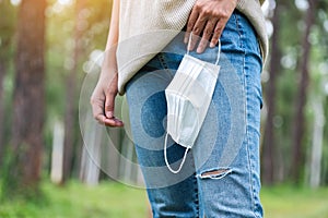 A woman holding a protective face mask for Healthcare concept