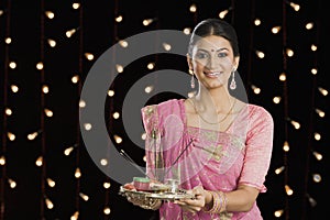 Woman holding a puja thali on Diwali photo