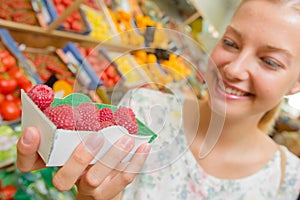 Woman holding punnet raspberries