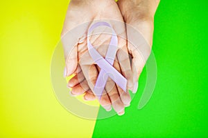 Woman holding purple ribbon, domestic violence awareness