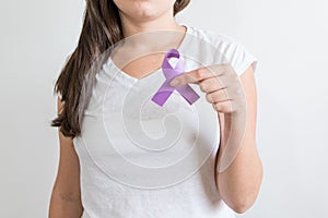 Woman holding a purple ribbon of the International Day for the Elimination of Violence Against Women photo