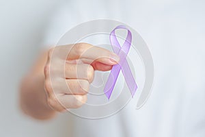 woman holding Purple Ribbon for Stomach, Violence, Pancreatic, Esophageal, Testicular cancer, Alzheimer, epilepsy, lupus,