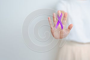 Woman holding purple Ribbon for Violence, Pancreatic, Esophageal, Testicular cancer, Alzheimer, epilepsy, lupus, Sarcoidosis and