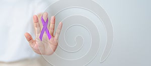 Woman holding purple Ribbon for Violence, Pancreatic, Esophageal, Testicular cancer, Alzheimer, epilepsy, lupus, Sarcoidosis and