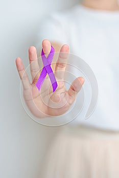 Woman holding purple Ribbon for Violence, Pancreatic, Esophageal, Testicular cancer, Alzheimer, epilepsy, lupus, Sarcoidosis and