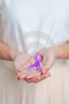 Woman holding purple Ribbon for Violence, Pancreatic, Esophageal, Testicular cancer, Alzheimer, epilepsy, lupus, Sarcoidosis and