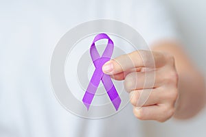 Woman holding purple Ribbon for Violence, Pancreatic, Esophageal, Testicular cancer, Alzheimer, epilepsy, lupus, Sarcoidosis and