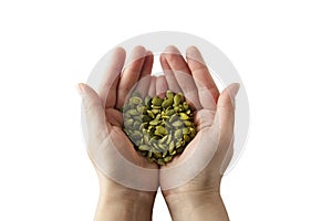 Woman holding raw unshelled pumpkin seeds, closeup view, isolated. Healthy, vegetarian super food or snack. Template for design