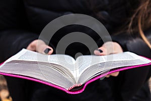 Woman holding and reading bible