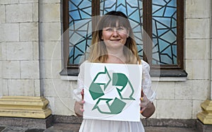 Woman holding recycling sign. Ecology concept