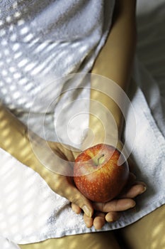 Woman holding a red apple