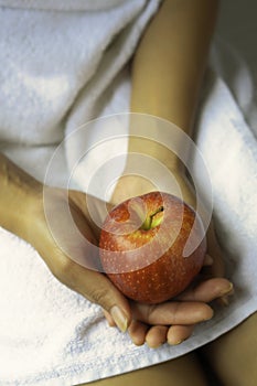 Woman holding a red apple