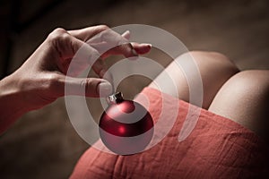 Woman holding a red Christmas globe