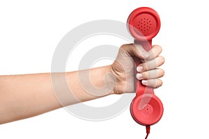 Woman holding red corded telephone handset on white background, closeup. Hotline concept