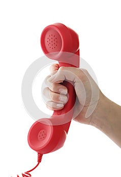 Woman holding red corded telephone handset on white background. Hotline concept