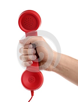 Woman holding red corded telephone handset on white background. Hotline concept