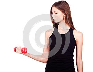 A woman holding a red dumbbell