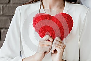 Woman holding red heart