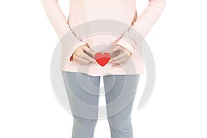 Woman holding red heart put on the genitalia area, Penis pain or Itching urinary Health-care concept on white background photo