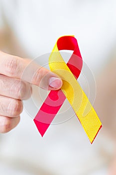 woman holding Red and Yellow ribbon. World hepatitis day awareness month, 28 July, Liver cancer, Jaundice, Cirrhosis, Failure,