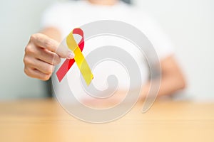 woman holding Red and Yellow ribbon. World hepatitis day awareness month, 28 July, Liver cancer, Jaundice, Cirrhosis, Failure,