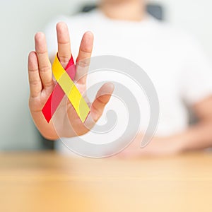 woman holding Red and Yellow ribbon. World hepatitis day awareness month, 28 July, Liver cancer, Jaundice, Cirrhosis, Failure,