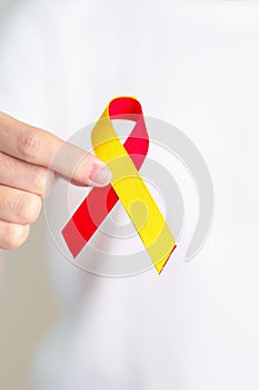 woman holding Red and Yellow ribbon. World hepatitis day awareness month, 28 July, Liver cancer, Jaundice, Cirrhosis, Failure,