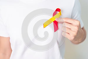 woman holding Red and Yellow ribbon. World hepatitis day awareness month, 28 July, Liver cancer, Jaundice, Cirrhosis, Failure,