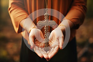 Woman holding a religious cross, christian church, belief and faith concept, catholic and protestant community