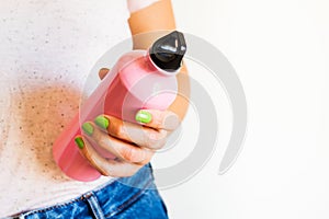 Woman holding reusable water bottle