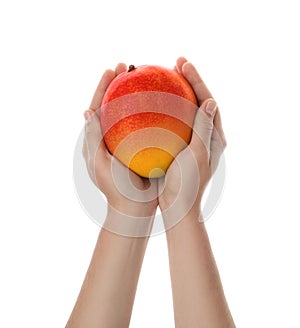 Woman holding ripe exotic mango on background, closeup