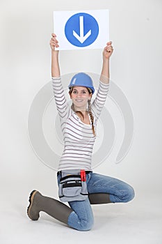 Woman holding road sign