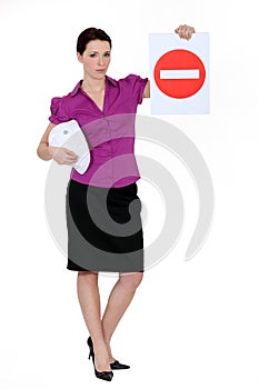 Woman holding road sign