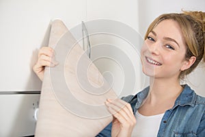 woman holding roll veneer to revamp kitchen cupboards