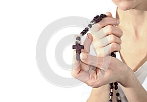 Woman holding a rosary beads cross in her hands
