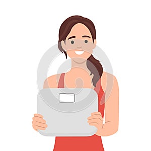 Woman holding scales in hands worried about body weight and figure. Female with weighing scales anxious about diet and weightloss