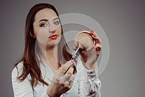 Woman holding a set of cosmetic brushes for make-up