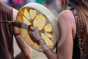 Woman holding shamanic frame drum