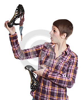 Woman holding a shoe climbed by a tiny girl