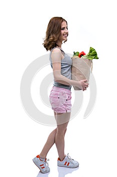 Woman holding a shopping bag full of groceries