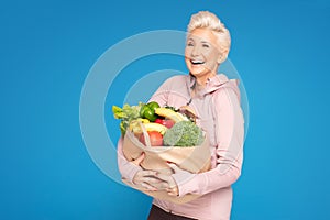 Woman holding shopping bag with healthy food