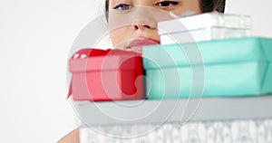 Woman holding shopping bag with stack of gift boxes