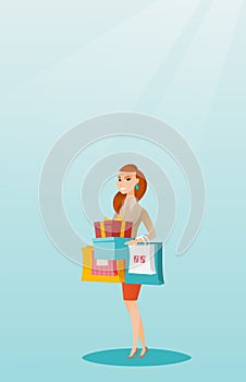 Woman holding shopping bags and gift boxes.