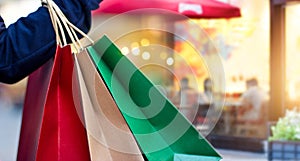 Woman holding shopping bags on mall street background photo